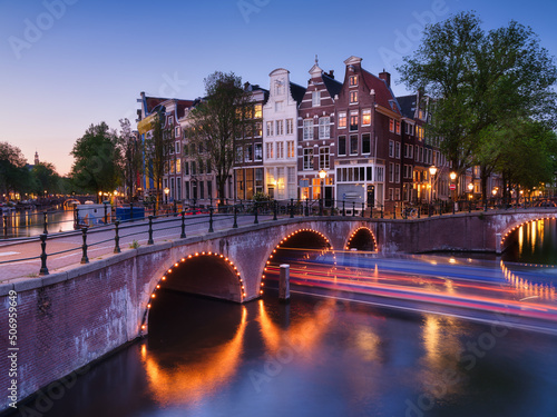 Amsterdam, Netherlands. View of houses and bridges during sunset. The famous ...
