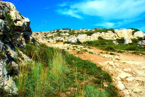 Vászonkép Rugged trail making its way through the rocks of a canyon partly covered by beau
