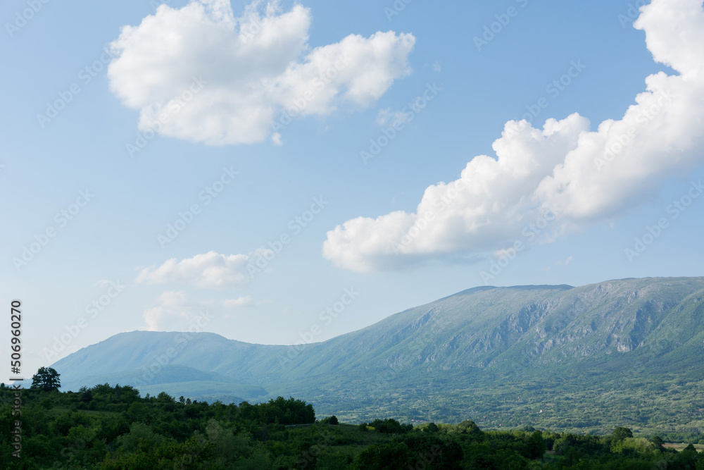 Beautiful panorama view of Suva Planina, a chain of mountains and hills in Serbia, with forests, hills and agricultural fields on a spring sunny day