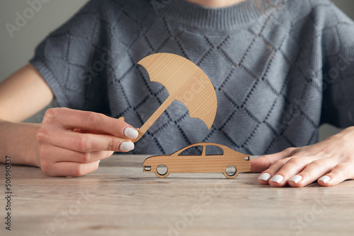 woman hand holding umbrella and cover car toy