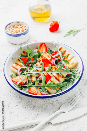 Grilled halumi salad with pine nuts, strawberries and arugula.