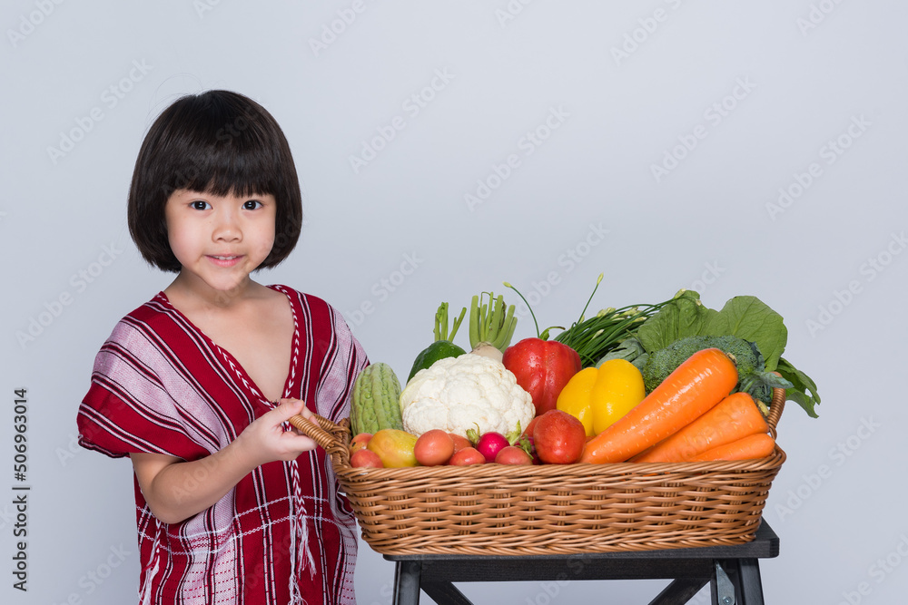 kid with vegetables basket on white background
kid with vegetables basket on white background