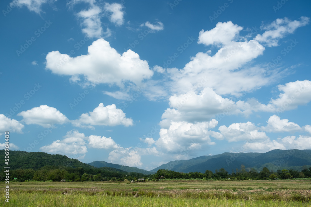 The white clouds have a quaint and rural shape. The sky is cloudy and blue The white clouds have a quaint and rural shape. The sky is cloudy and blue