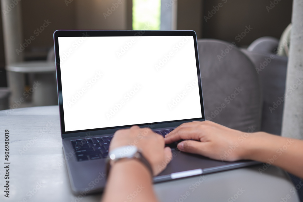 Mockup image of a woman working and typing on laptop with blank white desktop screen Mockup image of a woman working and typing on laptop with blank white desktop screen