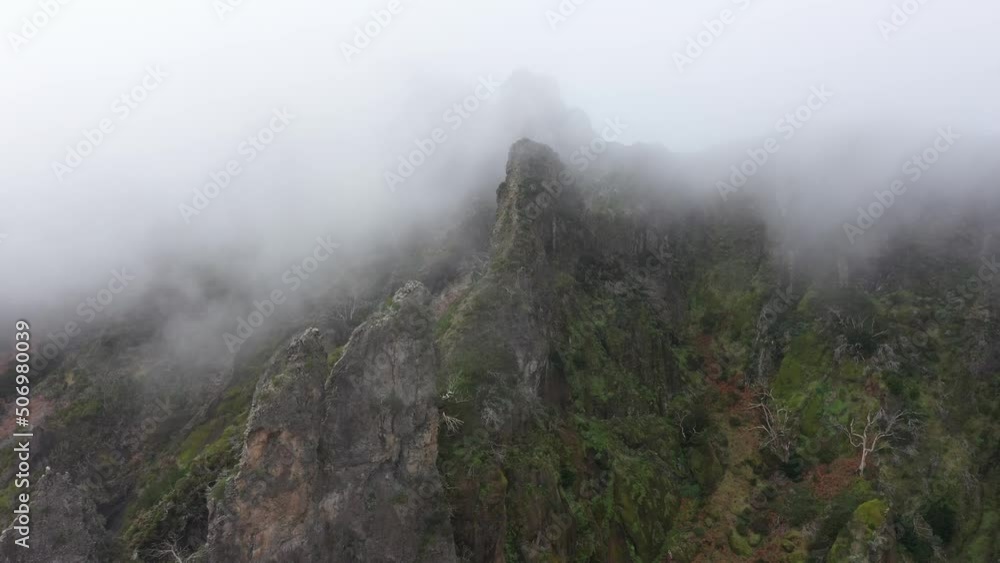 Drone shot moving forwards over the cliffs of Nuns Valley in Madeira. Thin clouds moving up the peaks. Drone shot moving forwards over the cliffs of Nuns Valley in Madeira. Thin clouds moving up the peaks.