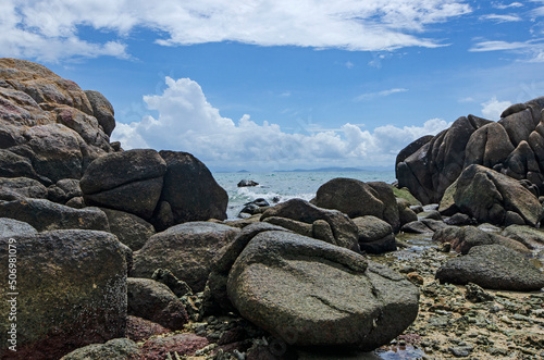 Beautiful rocks with blue sea and cloudy sky background