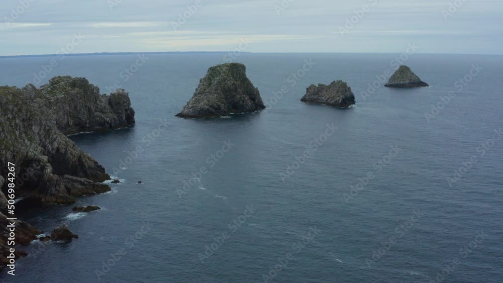 Aerial shot over the cliffs and rocky islands in the ocean, in Brittany, France Aerial shot over the cliffs and rocky islands in the ocean, in Brittany, France