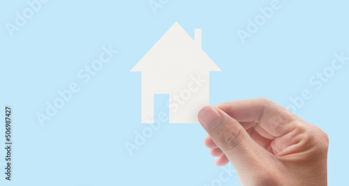 Hands holding paper house  family home