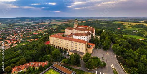 Pannonhalma, Hungary - Aerial panoramic view of the beautiful Millenary Benedictine Abbey of Pannonhalma (Pannonhalmi Apatsag) with blue sky and green foliage at summertime photo
