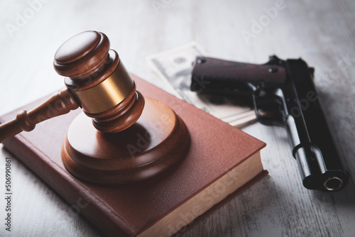 court gavel with a gun on the table