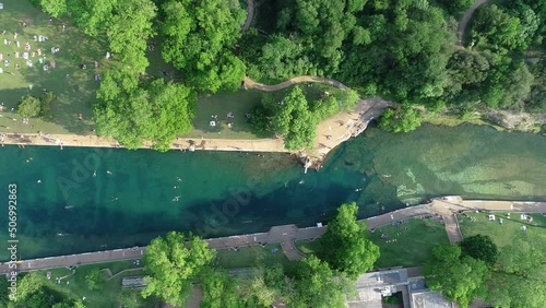 Aerial drone footage of people swimming at the Barton Springs Pool in Austin, Texas. Interesting fact, Robert Redford learned how to swim in this very pool when he was just 5 years old. photo