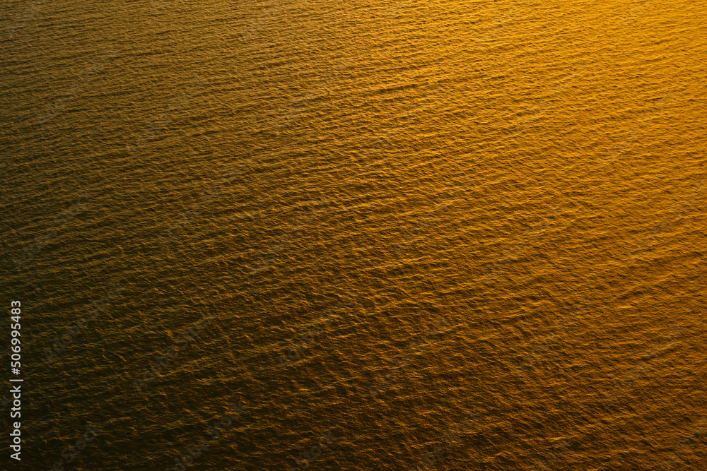 Naklejka premium The golden sea and wave before sunrise.