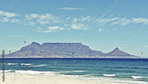 Landscape with kite surfer having fun on the Atlantic ocean and Table Mountain in the background mixed media photo