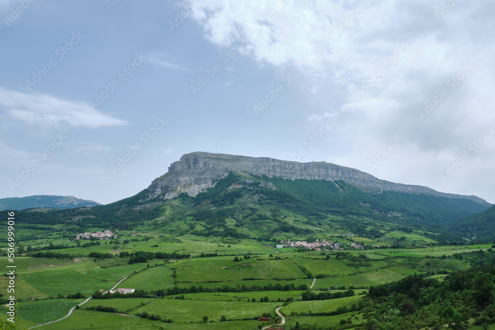 panoramic view of uanu and torrano small town in the ergoyena valley at the foot of the sierra de san donato surrounded by large meadows. rural tourism. Navarre, Spain