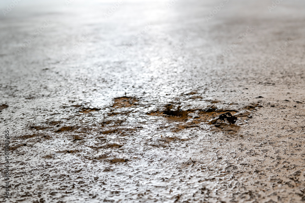 Driveway surface damage. Roadway grunge texture. Close up of bubbling