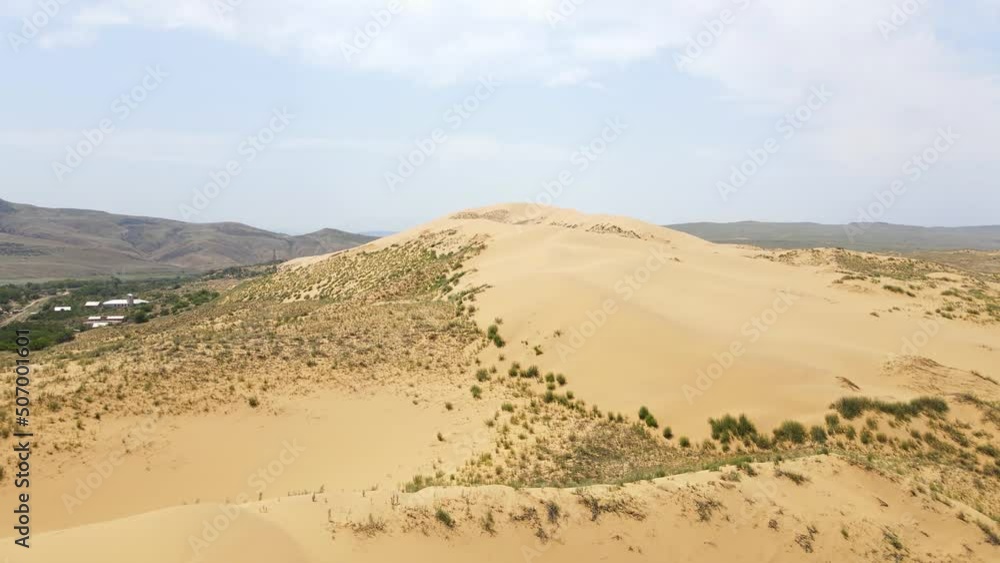 Sarykum is the largest sand dune in Europe. Dagestan nature reserve. Caucasian sand dune. Emotional natural landscape of Russia. Tourist attraction. Drone view Sarykum is the largest sand dune in Europe. Dagestan nature reserve. Caucasian sand dune. Emotional natural landscape of Russia. Tourist attraction. Drone view
