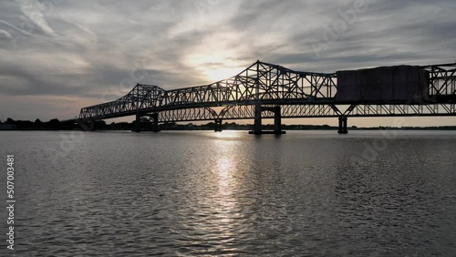 Aerial view of the sun setting over the Atchafalaya River and hwy 90 bridge between Berwick and Morgan City, Louisiana photo