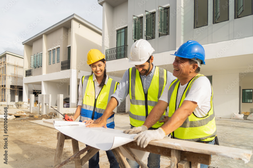 A group of workers, a designer team talk, communicate, discuss, and working on industrial construction site at home architecture building project. People lifestyle. A group of workers, a designer team talk, communicate, discuss, and working on industrial construction site at home architecture building project. People lifestyle.