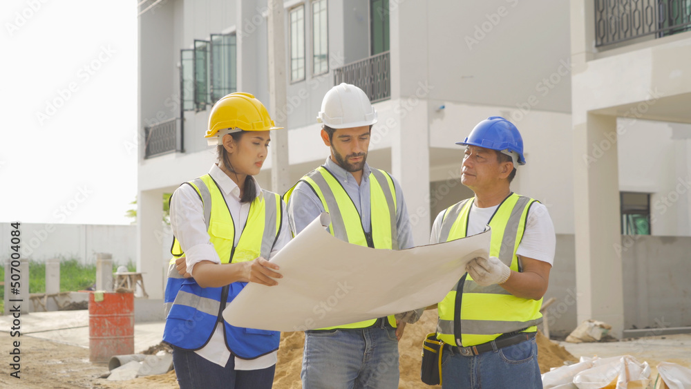A group of workers, a designer team talk, communicate, discuss, and working on industrial construction site at home architecture building project. People lifestyle. A group of workers, a designer team talk, communicate, discuss, and working on industrial construction site at home architecture building project. People lifestyle.