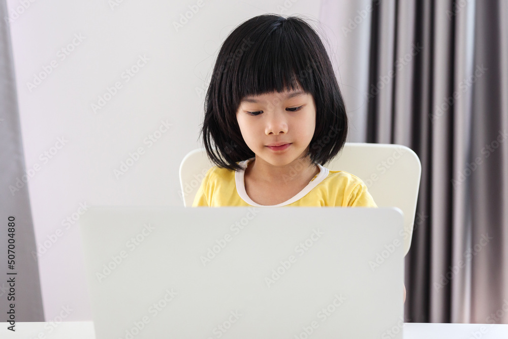 little asian girl student study online using laptop computer at home little asian girl student study online using laptop computer at home