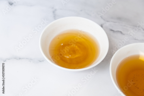 Tea drops fall into a cup. Tea ceremony concept