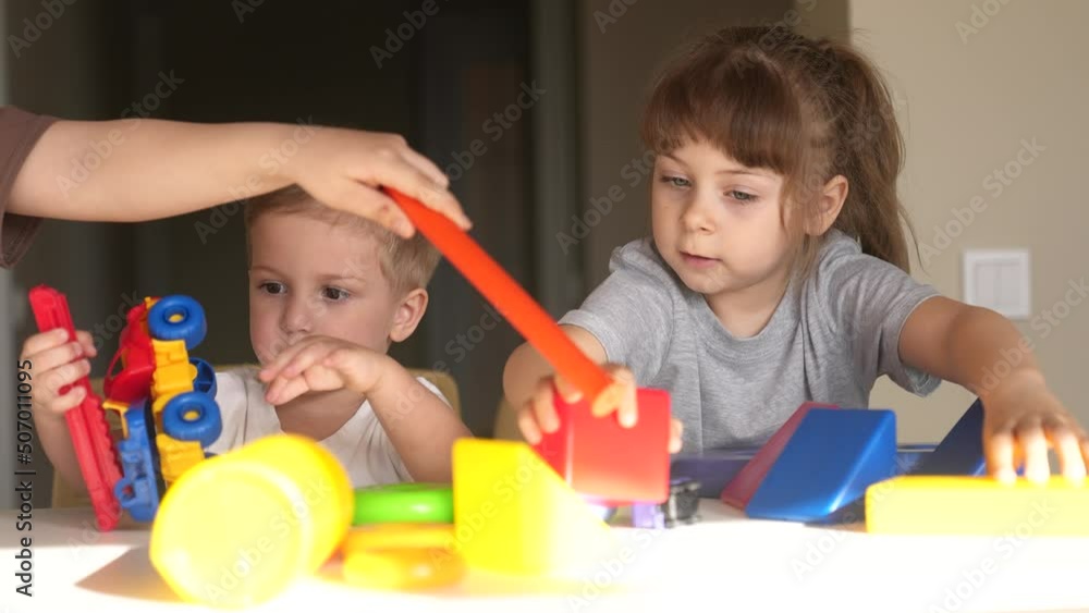 kindergarten. a group of children play toys lifestyle cubes and cars on the table in kindergarten. kid dream creative happy family preschool education concept. nursery baby toddler home kindergarten. a group of children play toys lifestyle cubes and cars on the table in kindergarten. kid dream creative happy family preschool education concept. nursery baby toddler home