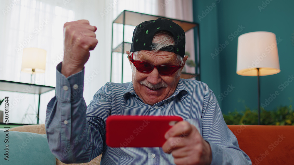 Worried funny senior old grandfather man enthusiastically playing
