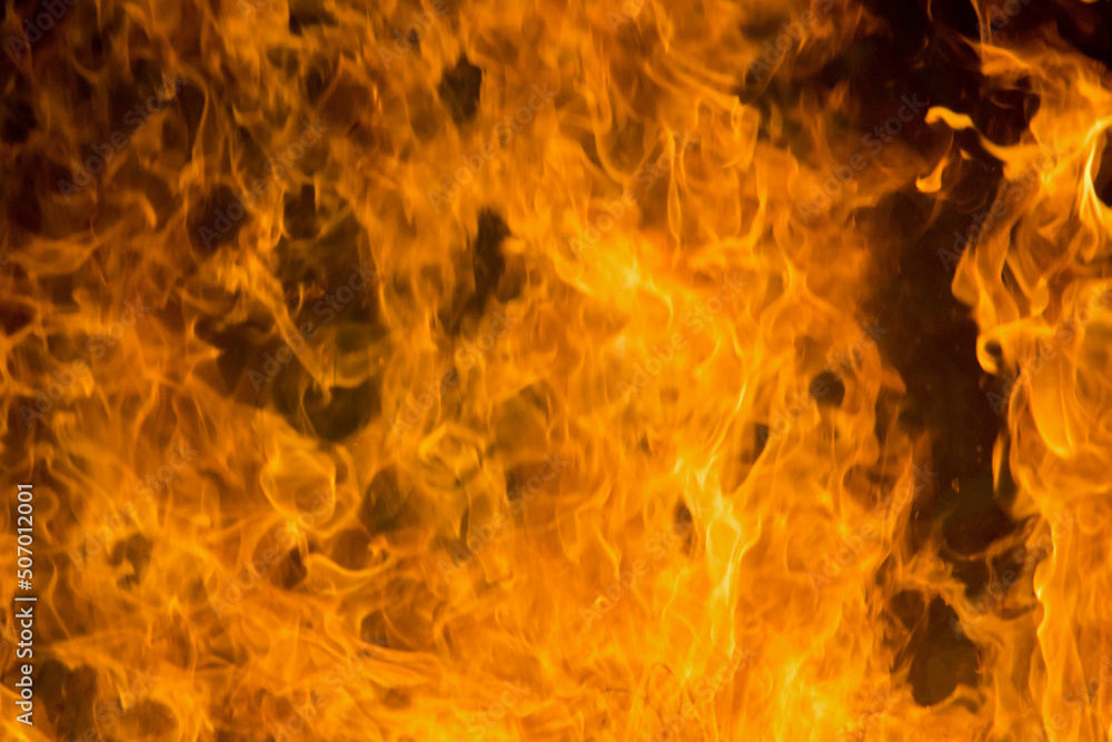 Close up burning flames on black background for graphic design or wallpaper Close up burning flames on black background for graphic design or wallpaper