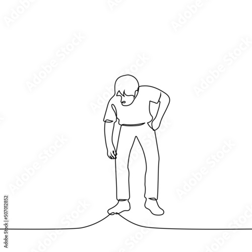 man bent down to pick up something - one line drawing vector. concept bent over the ground; drop something or find something