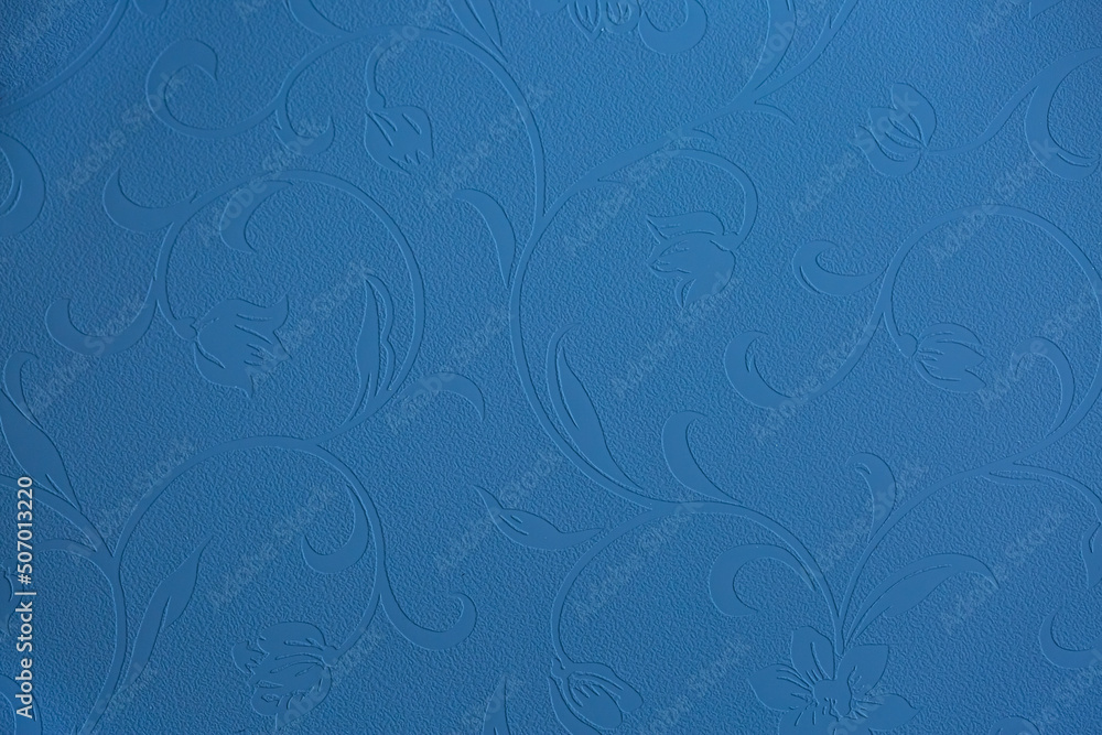 Blue background of decorative plaster with abstract spots. Unusual texture of this wall with beautiful patterns, creative surface background. Finishing coating for building cladding.