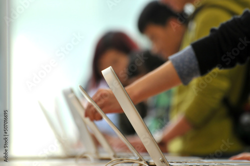 People buying laptop in electronics store photo