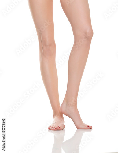 Front view of beautifully cared women's legs and feet on white background © vladimirfloyd