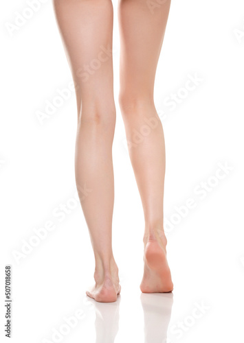 Rear view of beautifully cared women's legs and knees on white background © vladimirfloyd