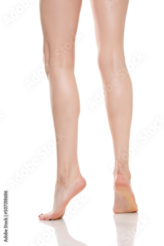 Rear view of beautifully cared women's legs and knees on white background © vladimirfloyd