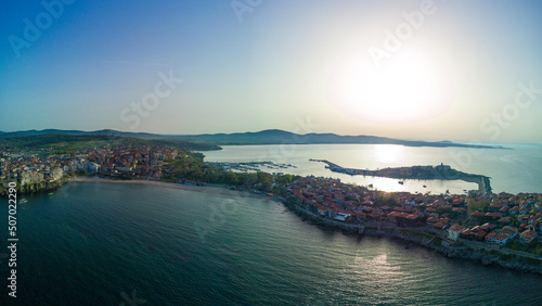 Fototapeta Naklejka Na Ścianę i Meble -  Panoramic view from a height above the town of Pomorie with houses and streets washed by the Black Sea in Bulgaria