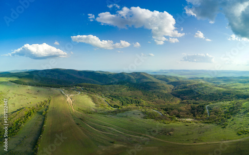 Panorama of a view from a height of the meadows and slopes of the Balkan Mountains under daylight in Bulgaria © YouraPechkin