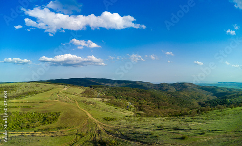 Fototapeta Naklejka Na Ścianę i Meble -  Panorama of a view from a height of the meadows and slopes of the Balkan Mountains under daylight in Bulgaria