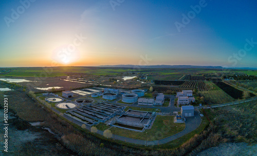 Panorama from above to tank farm with oil storage in fields and meadows near Black Sea coast under blue sky in Bulgaria