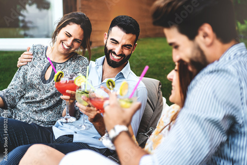 Sticker Cheerful group of adult friends having fun at backyard home garden party - young