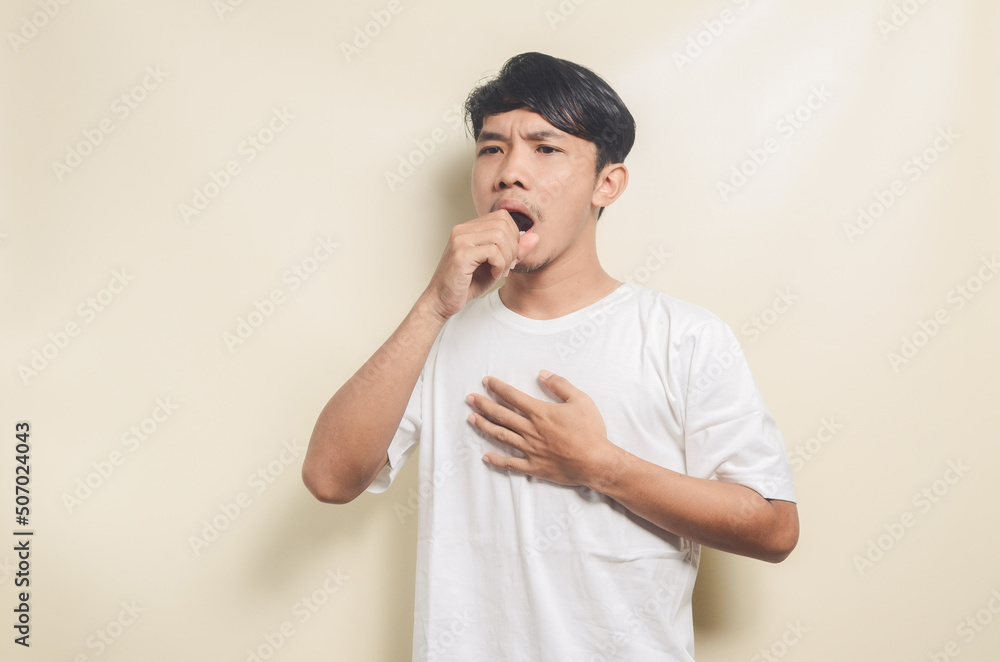 asian man wearing white t-shirt coughing on isolated background asian man wearing white t-shirt coughing on isolated background