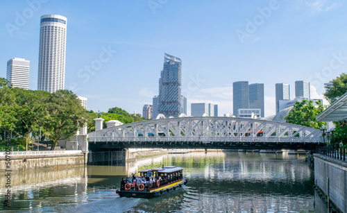 Photography Ferry Boat on Singapore River, Bridge, and City Skyline in Background - Singapor
