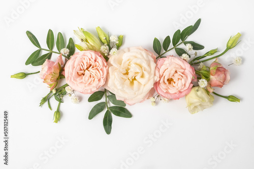 floral layout of pink roses on a white background. Top view. Spring or summer floral background with copy space.
