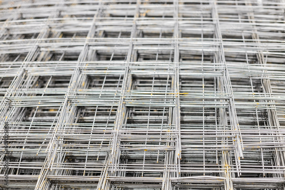 Steel cage reinforcement for reinforced concrete for construction. Iron reinforcement mesh. Building materials. Blurry, focus with a small depth of field.