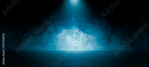 The dark stage shows, empty dark blue scene background, neon light, and spotlights The asphalt floor and studio room with smoke float up the interior texture for display products.