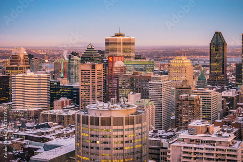 Montreal, Qc, Canada - January 8th 2021: View on Montreal skyscrapers and downtown buildings at sunset from the Kondiaronk belvedere, on top of Mount Royal (Quebec, Canada) photo