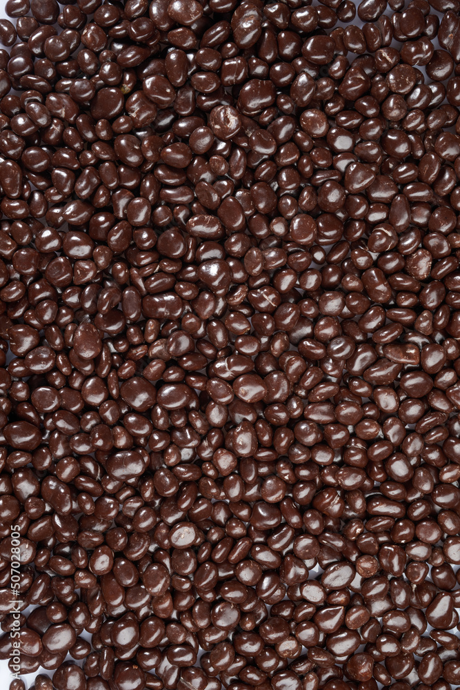 Chocolate candy texture. Sweets candy. Milk stone chocolate Candy Pebbles Top view background texture. 