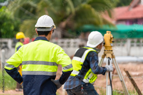 Surveyor Civil Engineer with equipment on the construction site.