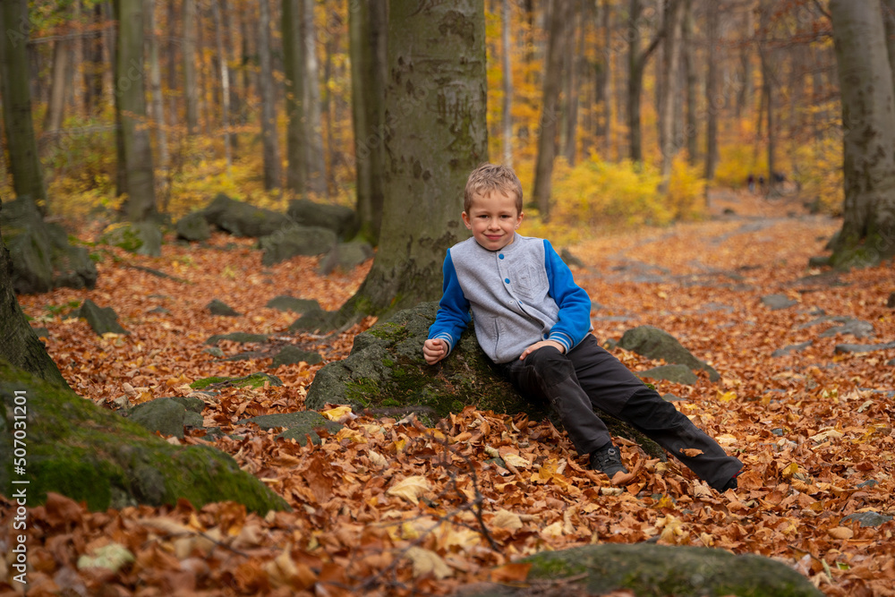 The little kid is going up the mountain trail. Fall season The little kid is going up the mountain trail. Fall season