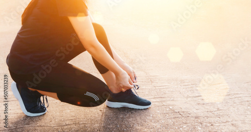 jogging shoes women tying shoelaces for autumn running in forest park runner try running shoes get ready for jogging. jogging girl motivation health and exercise.