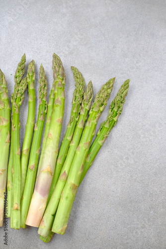 Green asparagus on a gray bockground. Seasonal fresh food